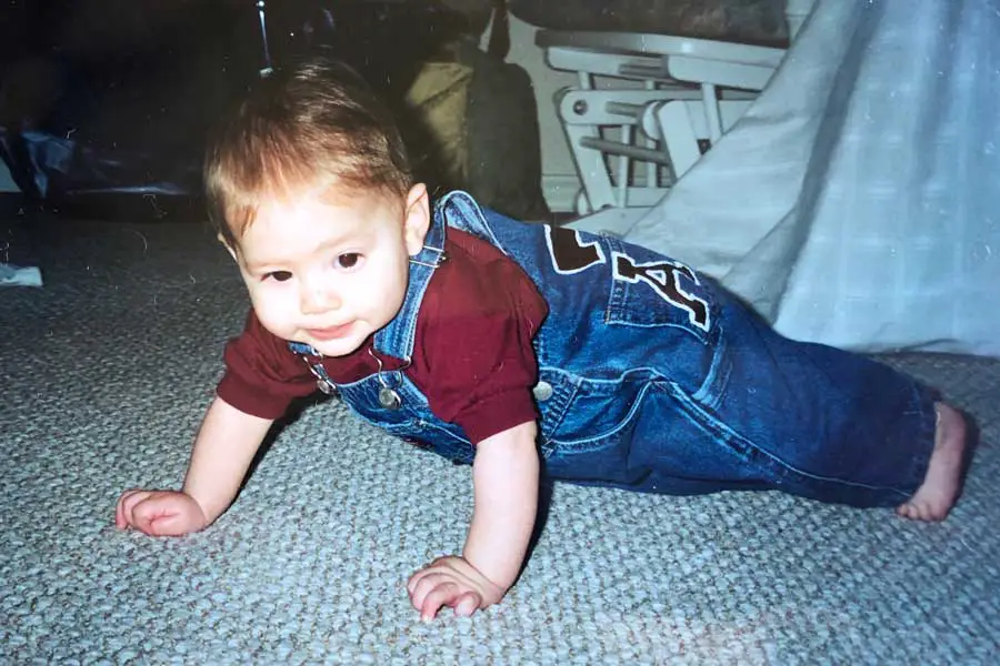 Guillermo Salinas as a child in overalls