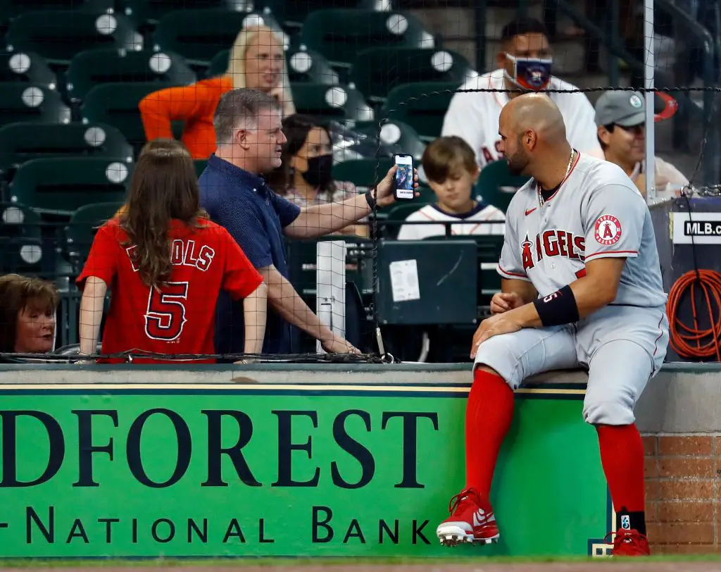 HOUSTON, TEXAS - APRIL 25: Albert Pujols #5 of the Los Angeles Angels talks fans prior to playing the Houston Astros at Minute Maid Park on April 25, 2021 in Houston, Texas. (Photo by Bob Levey/Getty Images)