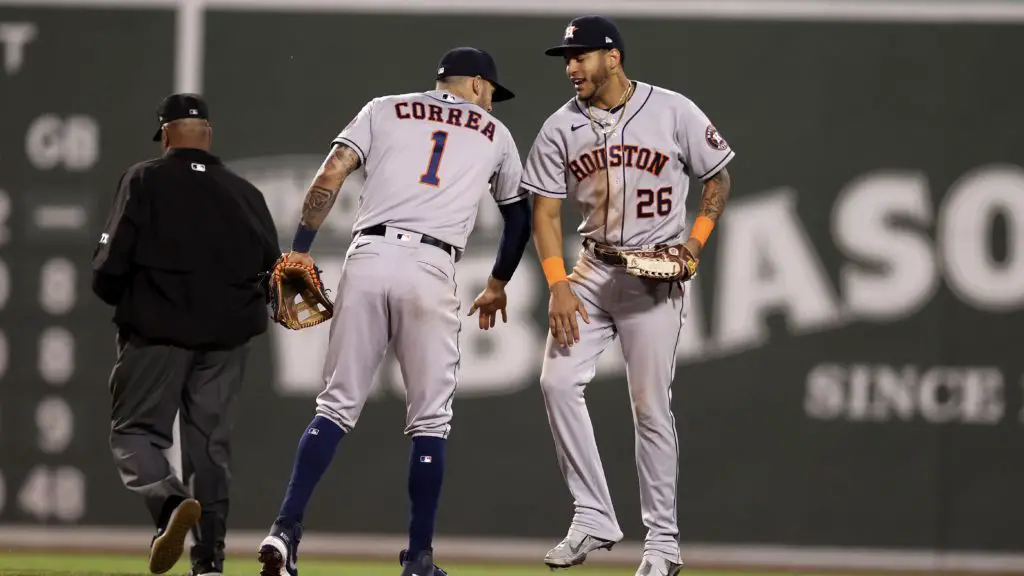 BOSTON, MASSACHUSETTS - OCTOBER 20: Carlos Correa #1 and Jose Siri #26 of the Houston Astros high five after they beat the Boston Red Sox in Game Five of the American League Championship Series at Fenway Park on October 20, 2021 in Boston, Massachusetts. (Photo by Maddie Meyer/Getty Images)