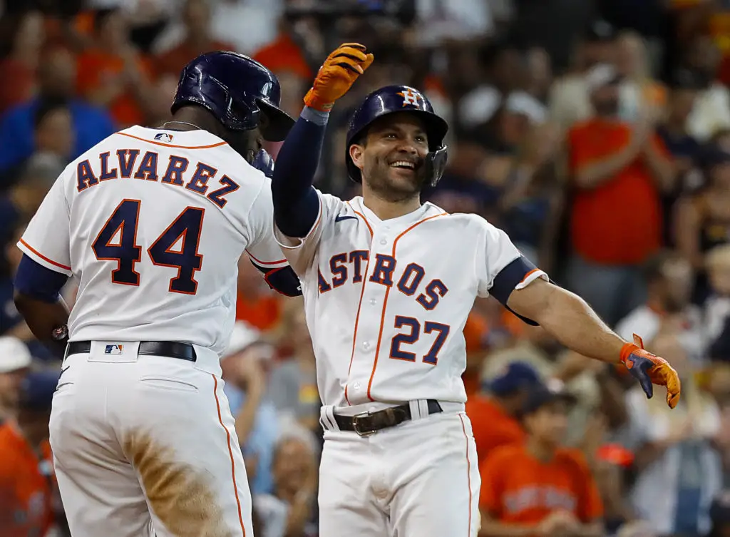 HOUSTON, TEXAS - JULY 02: Jose Altuve #27 of the Houston Astros receives a high five from Yordan Alvarez #4 after hitting a home run against the Los Angeles Angels at Minute Maid Park on July 02, 2022 in Houston, Texas. (Photo by Bob Levey/Getty Images)
