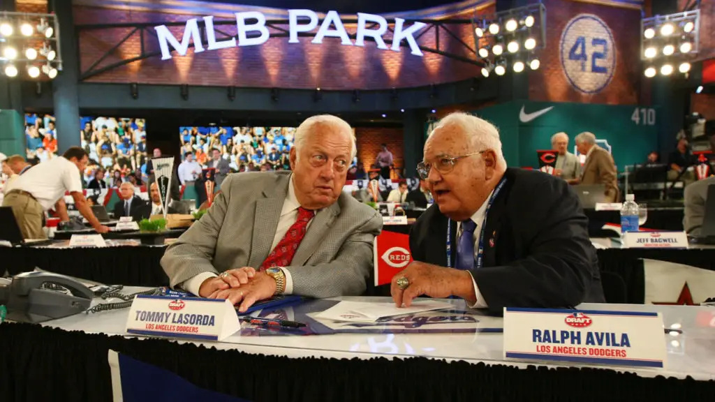 SECAUCUS, NJ - JUNE 07:  Team representative Tommy Lasorda and Ralph Avila both of the Los Angeles Dodgers look on during the MLB First Year Player Draft on June 7, 2010 held in Studio 42 at the MLB Network in Secaucus, New Jersey.  (Photo by Mike Stobe/Getty Images)