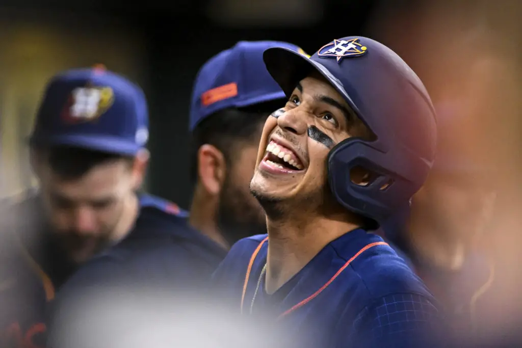 HOUSTON, TEXAS - APRIL 17: Mauricio Dubon #14 of the Houston Astros smiles in the dugout after scoring in the first inning against the Toronto Blue Jays at Minute Maid Park on April 17, 2023 in Houston, Texas. (Photo by Logan Riely/Getty Images)