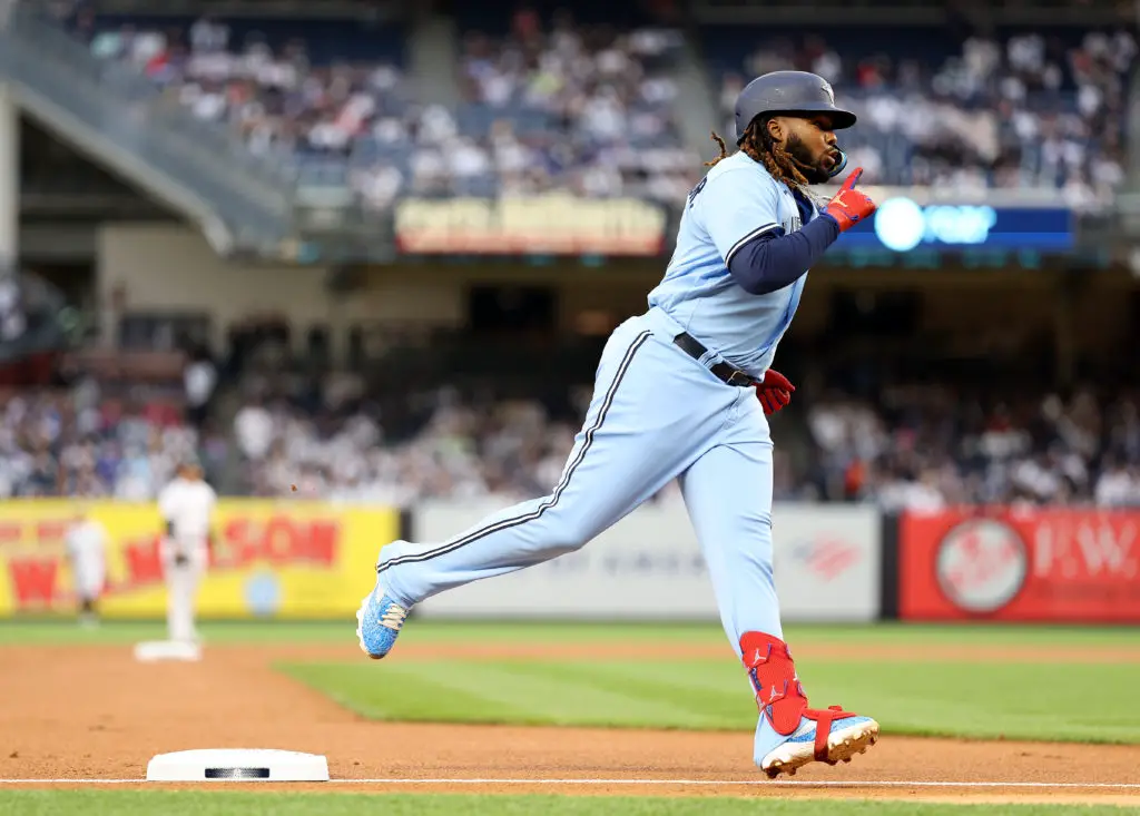 NEW YORK, NEW YORK - APRIL 21:  Vladimir Guerrero Jr. #27 of the Toronto Blue Jays celebrates as he rounds third base after he hit a two run home run in the first inning against the New York Yankees at Yankee Stadium on April 21, 2023 in the Bronx borough of New York City. (Photo by Elsa/Getty Images)